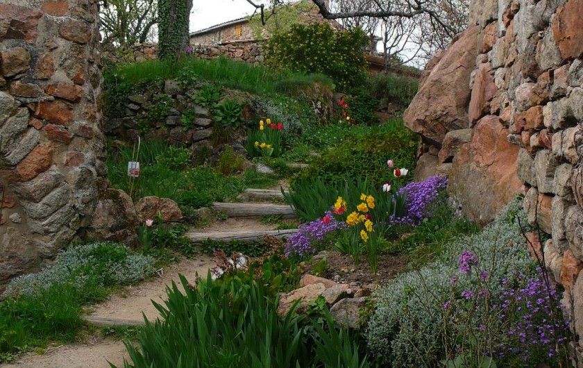 Location de vacances - Camping à Saint-Julien-du-Gua - L’escalier d’accès aux gîtes embelli par les fleurs du printemps